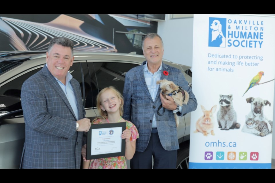 Rick Perciante (left), OMHS' Exec. Director, Frank Apa (right), President of Lexus of Oakville, and Lillian Parsons (middle)